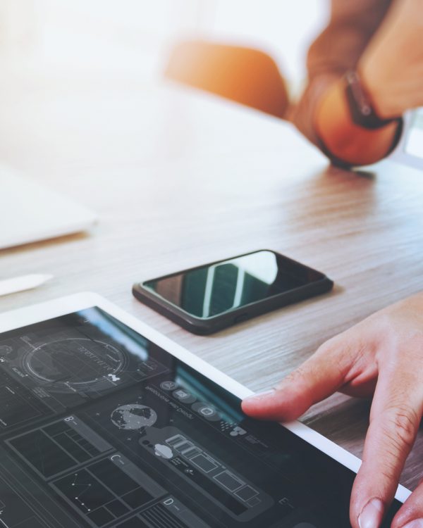working at a desk with mobile phone, tablet and laptop working at a desk with mobile phone, tablet and laptop